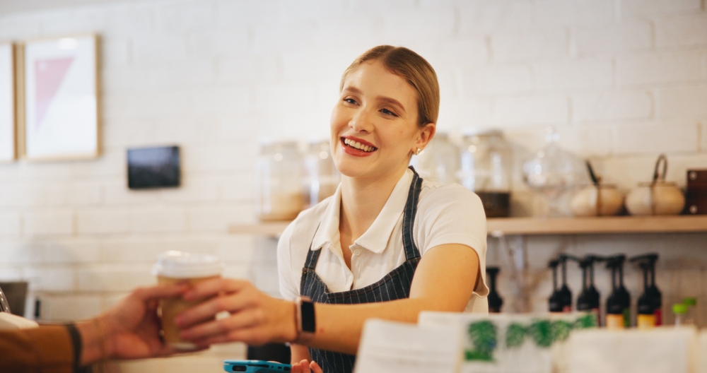 Women checking guest out on POS